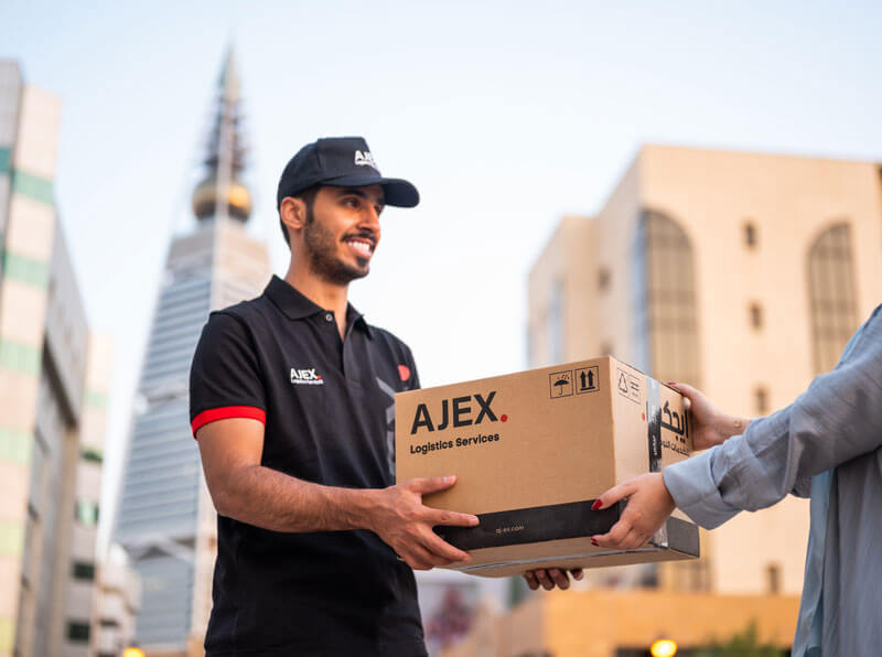 AJEX Courier guy giving shipemnt to a customer
